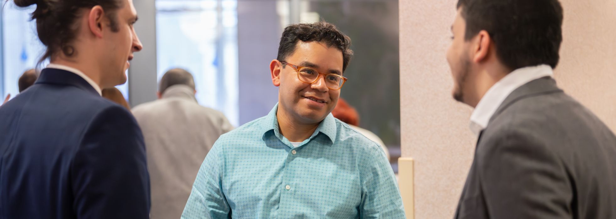 Dr. Caldera speaking to two other men in suits