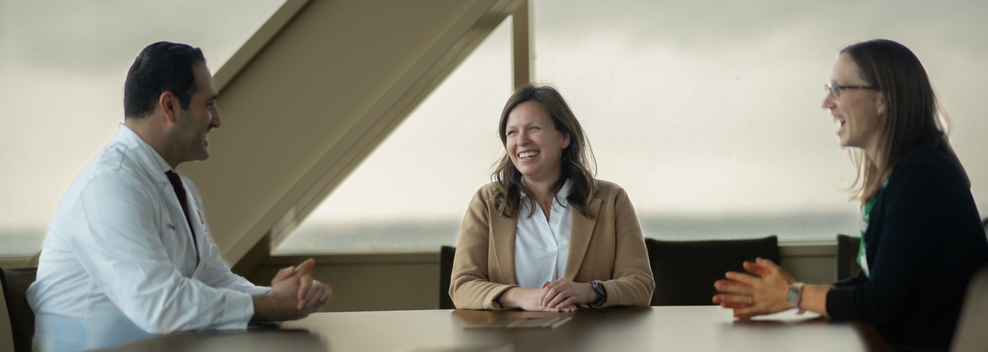 Dr. Sara Westergaard in conversation with colleagues