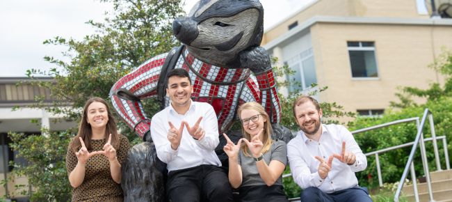 Haley Probst, Mazen Almasry, Geralyn Palmer, and Lucas Fass in front of a Bucky Badger statue