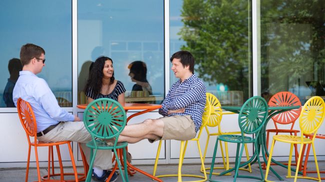Graduating residents sitting around a table outside