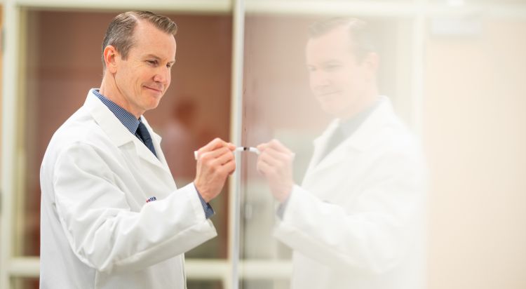 Dr. Mark Benson at the whiteboard