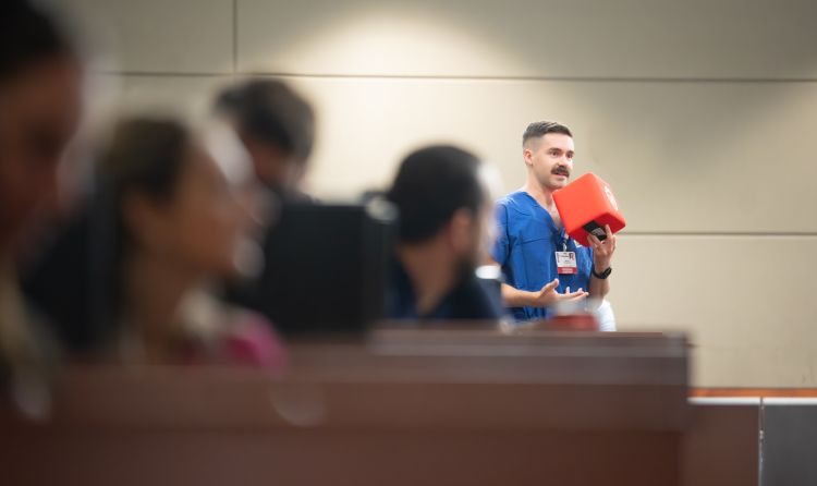 Michael Horowitz, PA, physician assistant-critical care, Allergy, Pulmonary and Critical Care Medicine, asks a question during Grand Rounds.