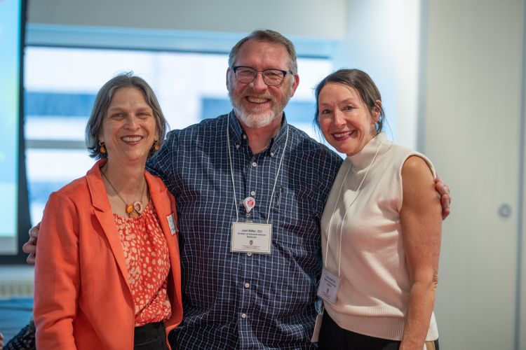 Photo of Dr. Joel Miller, in center, with his General Internal Medicine colleagues Betsy Trowbridge, MD, Kenneth D. Skaar, MD, Chair of Primary Care and division chief, on left, and Lisa Grant, DO, MSW, clinical professor, on right.