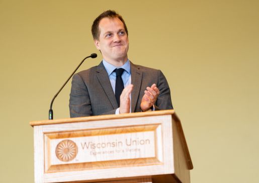 Residency Director Andy Coyle, MD, stands at the podium of the graduation ceremony