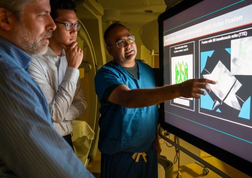 Medical student and Shapiro Summer Research Program participant Jonathan Le (center), along with co-mentors Michael Speidel, PhD (left), and Amish Raval, MD (right), evaluate ways to potentially combine x-ray fluoroscopy and ultrasound imaging for interventional cardiology procedures.