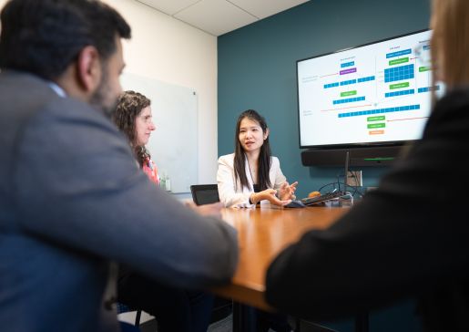 Group photo of ICU Data Science lab members talking around a conference room table