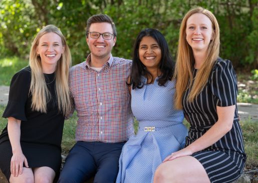 Photo of the 2023-2024 chief residents sitting in a row on a low wall outside