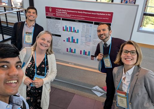Clinical informatics faculty and fellows display their poster at a recent conference