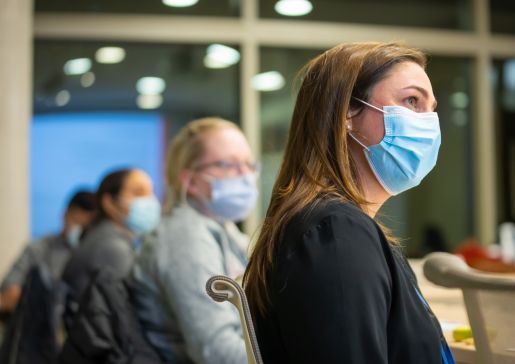 Drs. Marina Sharifi, Dana Ley, and Sara Donohue watching someone out-of-frame speak