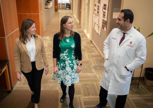 Dr. Sara Westergaard and collaborators walking down a hallway