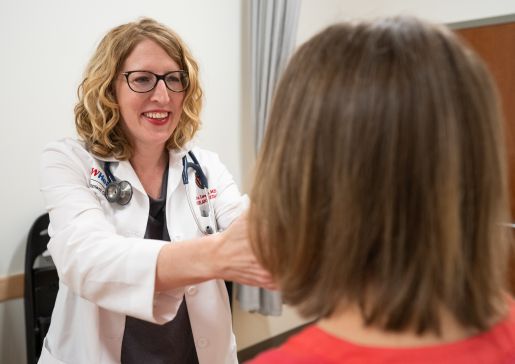 Dr. Erin Lowery examines a patient in the UW Health transplant clinic