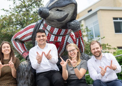 Haley Probst, Mazen Almasry, Geralyn Palmer, and Lucas Fass in front of a Bucky Badger statue